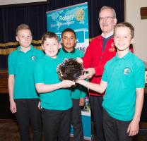 Assistant Governor, Ken McLennan presents winners, Hazlehead School, with their trophy